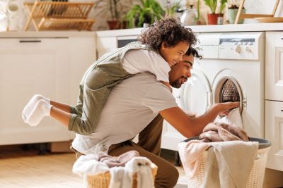 Father and son doing laundry together